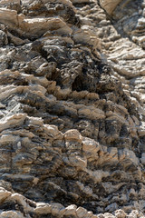 Compressed rock layers formation in various colors and thicknesses, on south central coast of the  Mediterranean island Crete, Greece. Nature and Geological science concept