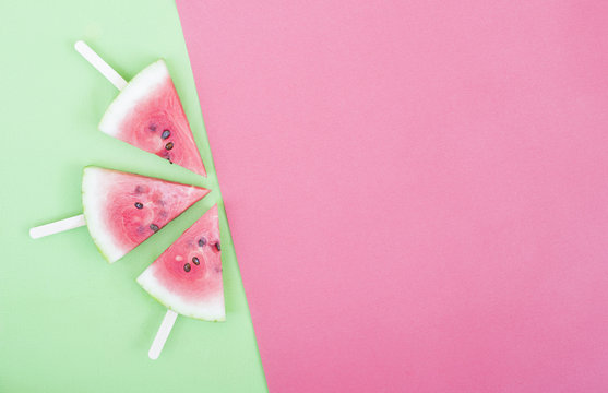 three watermelon slices on red background