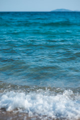 Gentle waves crashing on a sandy beach