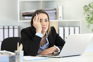 Frustrated executive looking at camera at office