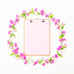 Pink flower frame with clipboard on white background. Flat lay, Top view. Flower concept.
