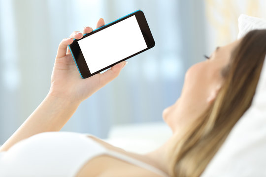 Woman using a phone showing mockup screen