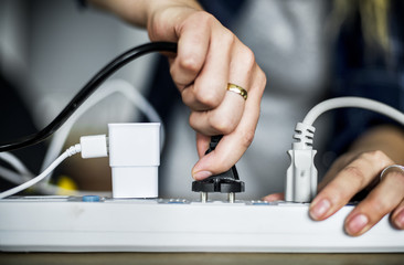 Woman pluging the wire