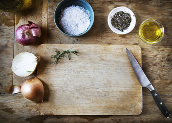 Cutting board and vegetables on a wooden table