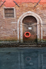Life Preserver Hanging on a Door on a Canal in Venice, Italy