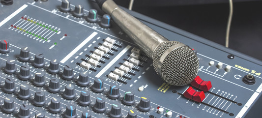 Microphones and mixers on the table.