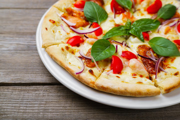Seafood pizza background with shrimps, basil leaves and melted cheese. Fast food, fattening, junk food concept