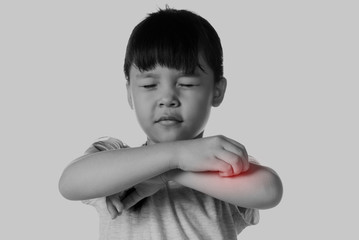 Portrait of a young asian girl scratching her arm.