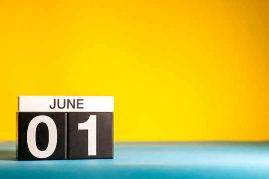 June 1st. Day 1 of june month, calendar on table with yellow background. Summer time, empty space for text