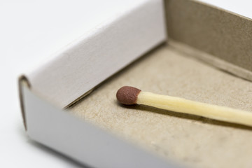 single matchstick with a box