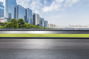 Fototapeta premium Panoramic skyline and modern business office buildings with empty road,empty concrete square floor