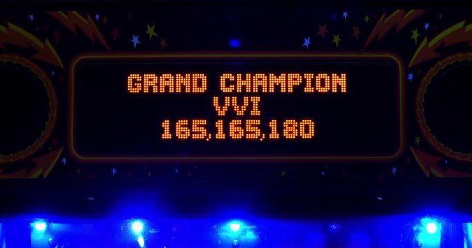 Close up of a high scores screen on a pinball machine in an arcade.