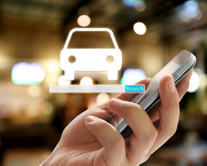 Hand of businessman holding a smartphone and have car symbol to search.