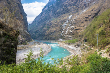 Naklejka na ściany i meble Mountain river in a deep gorge in the Himalayas.