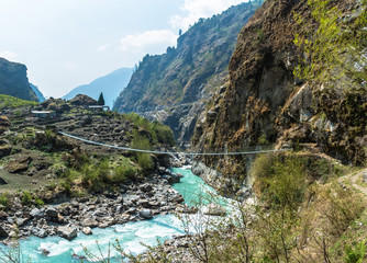 Fototapeta na wymiar Bridge over the mountain river in Nepal.