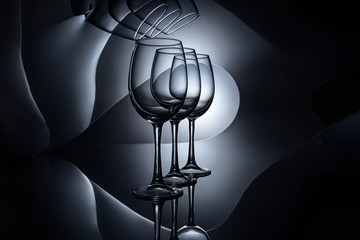 row on empty wine glasses, dark studio shot