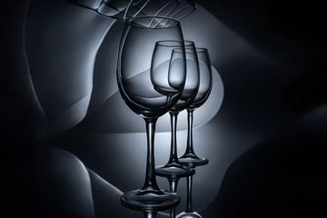row on empty luxury wine glasses, dark studio shot