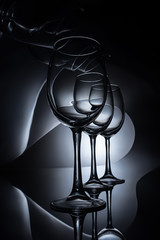 Fototapeta na wymiar row on elegant wine glasses, dark studio shot
