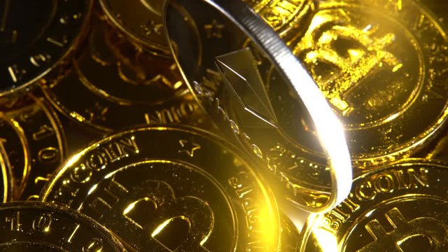 Extreme closeup and looking down on slow rotation of Ethereum coin rotating against gold Bitcoins.
