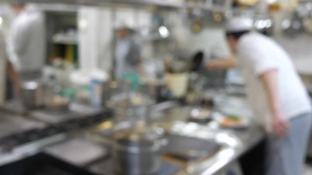 Blurred background kitchen in which cooks are cooked