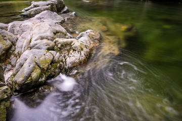 water rushing down the creek and caused swirl in the water