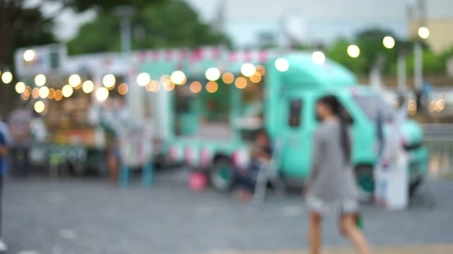 Abstract blurred footage of people walking at the food truck market