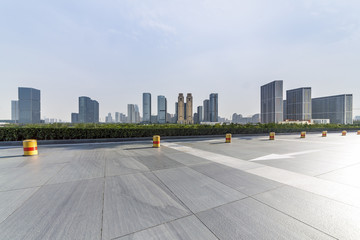 Panoramic skyline and buildings with empty concrete square floor