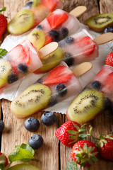 Homemade popsicles with berries and fruits close-up. vertical