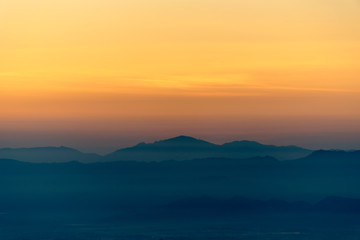 Fototapeta na wymiar Moutain range and mist at sunrise.