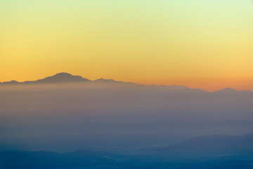 Fototapeta na wymiar Moutain range and mist at sunrise.