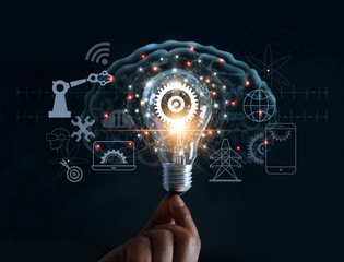 Hand holding light bulb and cog inside and innovation icon network connection on brain background,...
