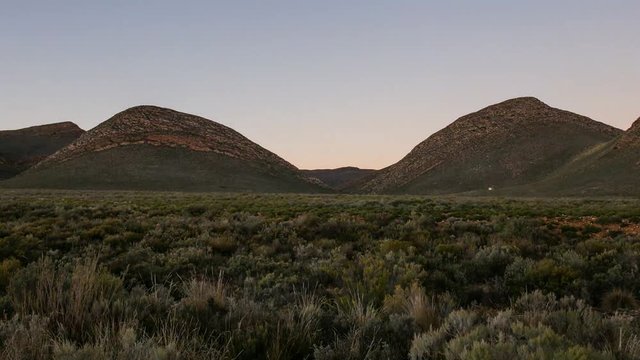 Time Lapse of the sunrise on gecko rock Karoo South Africa as the sun hits the peak of the mountain.