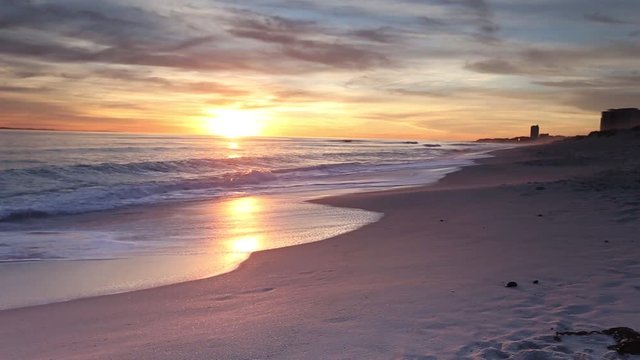 View of the sunset as seen from Blouberg beach looking towards robben island in cape town south africa