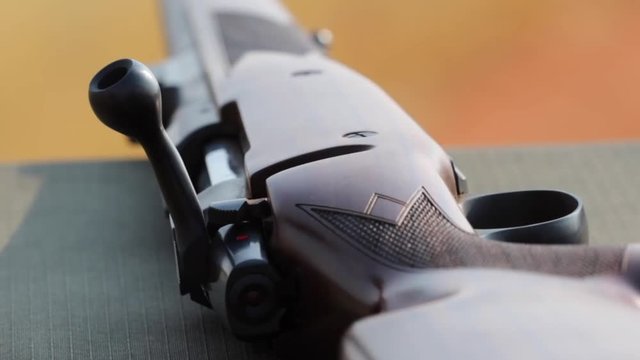 Rack focus from trigger to barrel of a heavy caliber hunting rifle