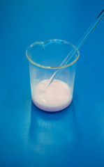 Soap making process in laboratory. Coloring and stirring with stirrer.