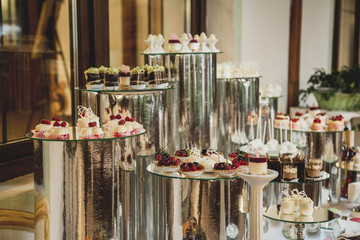 Beautiful candy bar of pink and white sweets decorated with figu