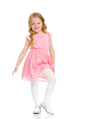 A cheerful little girl is dancing.