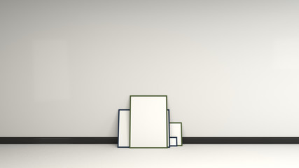 Blank white posters in black frames standing on the floor