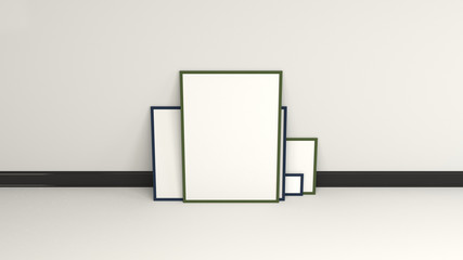 Blank white posters in black frames standing on the floor
