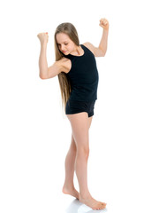 Obraz na płótnie Canvas A little girl shows her muscles.