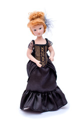 Porcelain doll with red hair in a long black vintage dress