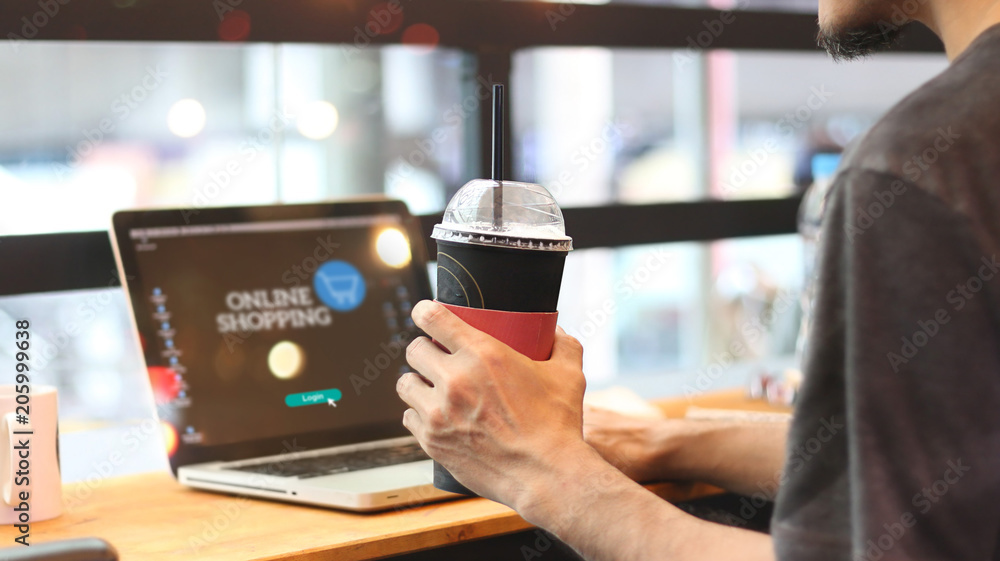 Poster Man with coffee in hand login online shopping website and payments on network connection screen. Technology. Digital and internet commercial buying.