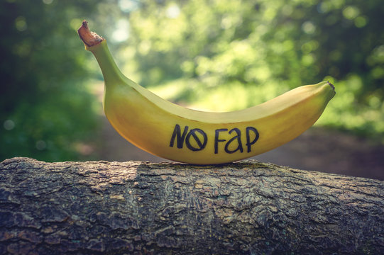 Banana with inscription "nofap" on stump like mens penis. Concept sexual problems.