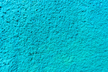close-up view of bright blue weathered wall texture
