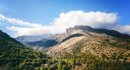 Fototapeta na wymiar Corsica, France, beautiful mountain landscape with clouds and blue sky