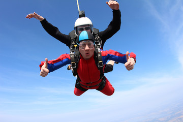 Fototapeta na wymiar Tandem skydiving. Two men are in the sky.