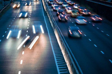 Speed Traffic - light trails on motorway highway at night, long exposure abstract urban background