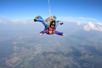 Tandem skydiving. Physically challenged woman is flying in the sky.