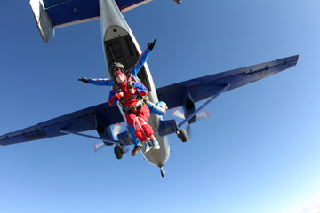 Fototapeta na wymiar Tandem skydiving. Physically challenged woman is flying in the sky.