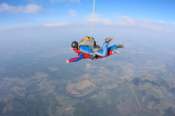 Tandem skydiving. Physically challenged woman is flying in the sky.